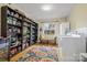 Well-organized laundry room with ample shelving, hardwood floors, and natural light from the window at 1008 Candlewood Ln, Rock Hill, SC 29730