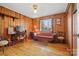 Cozy living room with wood paneled walls, hardwood floors, vintage furnishings and natural light at 1008 Candlewood Ln, Rock Hill, SC 29730