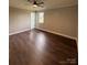 Bright bedroom with wood-look floors, ceiling fan, and exterior access at 129 Mapleleaf Rd, Statesville, NC 28625