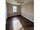 Spacious bedroom with dark wood-look flooring and ceiling fan at 129 Mapleleaf Rd, Statesville, NC 28625