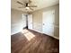 Bright bedroom with wood-look flooring, ceiling fan and access to another room at 129 Mapleleaf Rd, Statesville, NC 28625