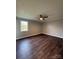 Spacious bedroom with dark wood-look flooring and ceiling fan at 129 Mapleleaf Rd, Statesville, NC 28625