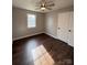 Bright bedroom with wood-look floors and ceiling fan at 129 Mapleleaf Rd, Statesville, NC 28625