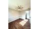 Well-lit bedroom with dark wood-look floors and a ceiling fan at 129 Mapleleaf Rd, Statesville, NC 28625