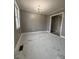 Bright dining room features marble-look tile floors and a modern light fixture at 129 Mapleleaf Rd, Statesville, NC 28625