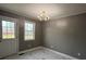 Bright dining room with chandelier and marble-look flooring at 129 Mapleleaf Rd, Statesville, NC 28625