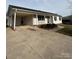 House exterior with a carport and landscaping, showcasing a wide driveway at 129 Mapleleaf Rd, Statesville, NC 28625