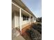 Side view of the house showing a covered porch and brick foundation at 129 Mapleleaf Rd, Statesville, NC 28625