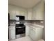 Renovated kitchen with stainless steel appliances and light cabinets at 129 Mapleleaf Rd, Statesville, NC 28625