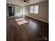 Open living room with dark brown flooring, showing access to other rooms at 129 Mapleleaf Rd, Statesville, NC 28625