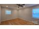 Bedroom with hardwood floors, ceiling fan and two windows at 1308 Princeton Ave, Gastonia, NC 28054