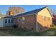 Rear exterior view of the brick home and green lawn at 1308 Princeton Ave, Gastonia, NC 28054