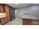 Well-lit kitchen featuring stainless steel appliances, granite countertops, and wood cabinets and flooring at 1308 Princeton Ave, Gastonia, NC 28054