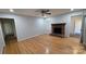 Cozy living room featuring a fireplace, hardwood floors, and a ceiling fan at 1308 Princeton Ave, Gastonia, NC 28054