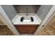 Close-up of bathroom sink with granite countertop and wood cabinets at 1308 Princeton Ave, Gastonia, NC 28054