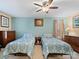 Relaxing bedroom with twin beds, light blue walls, and ceiling fan at 2430 Lazy Oak Dr, Lancaster, SC 29720