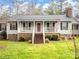 House with a front porch and American flag at 2430 Lazy Oak Dr, Lancaster, SC 29720