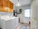 Bright laundry room with washer, dryer, cabinets, and exterior access at 2430 Lazy Oak Dr, Lancaster, SC 29720