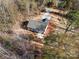 Aerial shot showing the home with a large yard and long driveway, nestled among the trees at 2503 Parnell Dr, Shelby, NC 28150