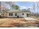 View of the home's backyard featuring a concrete patio, trees, and exterior with neutral siding at 2503 Parnell Dr, Shelby, NC 28150