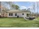 Beautifully staged backyard with a patio dining set sits on a large lawn, ready for entertaining at 2503 Parnell Dr, Shelby, NC 28150