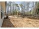 Home backyard featuring wooded area, small concrete patio, neutral siding and an air conditioning unit at 2503 Parnell Dr, Shelby, NC 28150