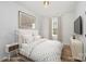 Inviting bedroom with neutral tones, featuring a cozy bed, side table, and soft natural light at 2503 Parnell Dr, Shelby, NC 28150