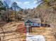 An aerial view highlights the home's exterior, long driveway, and spacious yard with a wooded perimeter at 2503 Parnell Dr, Shelby, NC 28150