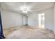 Spacious bedroom with ceiling fan, natural light, and two doorways to adjoining rooms at 2544 Harmony Rd, Rock Hill, SC 29730