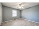 A gray bedroom with a window, neutral carpet, and a ceiling fan at 2544 Harmony Rd, Rock Hill, SC 29730