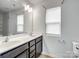 Bathroom with dark brown vanity, double sinks and a window at 2565 Meadow Crossing Dr, Dallas, NC 28034