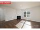 Living room featuring hardwood floors, fireplace and large windows at 3721 Cullen Meadows Dr, Davidson, NC 28036