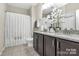 Well-lit bathroom with a granite countertop vanity, dark wood cabinets, and a shower-tub combo at 4146 La Crema Dr, Charlotte, NC 28214