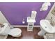 Bright half bathroom features a unique purple accent wall and a modern pedestal sink at 4146 La Crema Dr, Charlotte, NC 28214