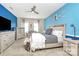 Bright bedroom featuring light wood furniture, modern ceiling fan, and serene blue accent wall at 4146 La Crema Dr, Charlotte, NC 28214
