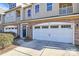 Townhome features a large garage with stylish brick and exterior lighting at 4146 La Crema Dr, Charlotte, NC 28214