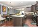 Modern kitchen with island seating, dark cabinets, and stainless steel appliances at 4146 La Crema Dr, Charlotte, NC 28214