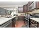 Well-equipped kitchen featuring granite countertops, dark wood cabinets, and stainless steel appliances at 4146 La Crema Dr, Charlotte, NC 28214