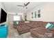 Spacious living room featuring a large sectional sofa, ceiling fan, and a wall-mounted TV at 4146 La Crema Dr, Charlotte, NC 28214