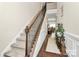 Elegant stairway with carpeted steps and wood railing, leading to the upper level at 4146 La Crema Dr, Charlotte, NC 28214