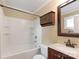 Bathroom featuring a tub and shower, vanity, storage, and a neutral color scheme at 549 Spring Sw St, Concord, NC 28025
