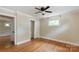 Cozy bedroom featuring hardwood floors, a ceiling fan, a window view and trim at 549 Spring Sw St, Concord, NC 28025