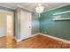 Bedroom featuring hardwood floors, a chandelier, closet, and unique wall color at 549 Spring Sw St, Concord, NC 28025