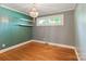 Bedroom featuring hardwood floors, open shelves, a chandelier, and large windows at 549 Spring Sw St, Concord, NC 28025