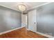 Bedroom featuring hardwood floors, closet, a chandelier, and neutral wall color at 549 Spring Sw St, Concord, NC 28025