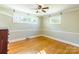 Hardwood floors and neutral walls in this bright bedroom at 549 Spring Sw St, Concord, NC 28025