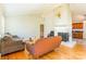 Living room with hardwood floors, fireplace, and view into kitchen at 549 Spring Sw St, Concord, NC 28025