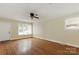 Spacious living room with hardwood floors, ceiling fan, and plenty of natural light at 549 Spring Sw St, Concord, NC 28025