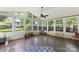 Bright sunroom with lots of windows and brick accents and a ceiling fan at 549 Spring Sw St, Concord, NC 28025