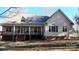 Inviting home exterior with a rear deck, pillars, and symmetrical window design at 8046 Lucky Creek Ln, Denver, NC 28037